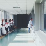 Medical professionals idly waiting in a hallway