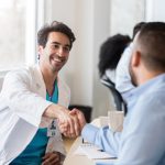 doctor shaking hands with an administrator, representing locum tenens interview questions
