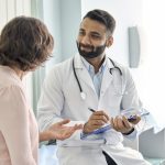 friendly smiling doctor providing a positive patient experience