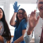 three happy healthcare providers with positive medical staff morale